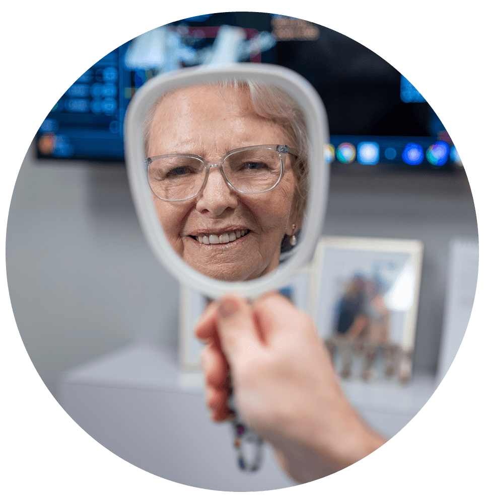 close up of dental patient smiling brightly looking at mirror