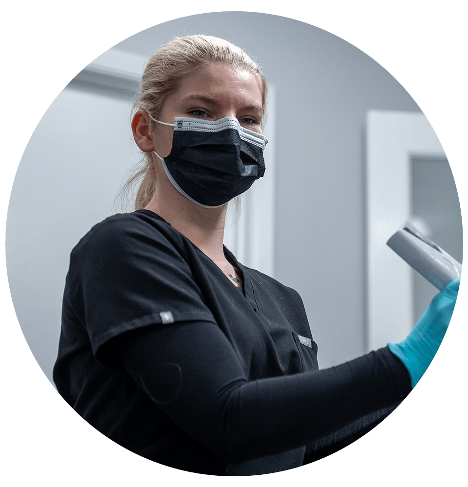 staff member performing dental examination
