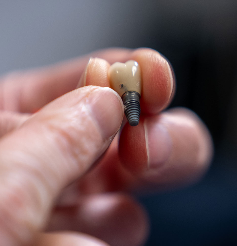 Dental specialist smiling with tools