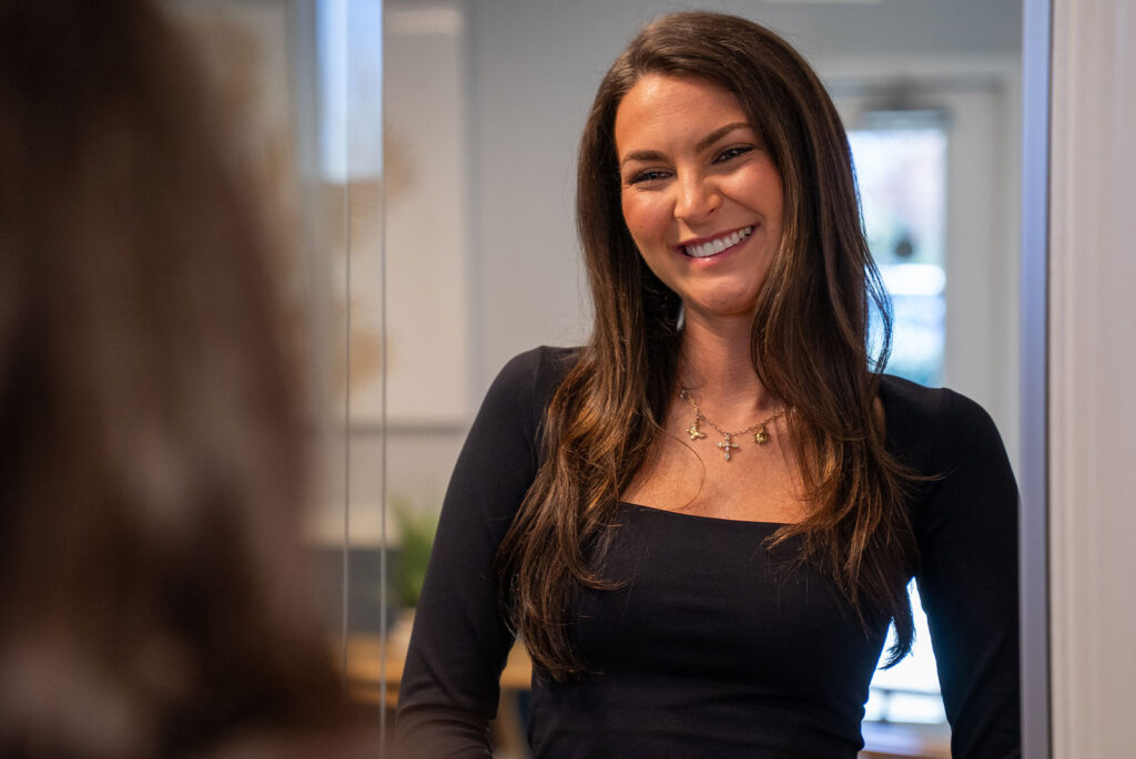 patient smiling while being helped at the front desk of the dental center