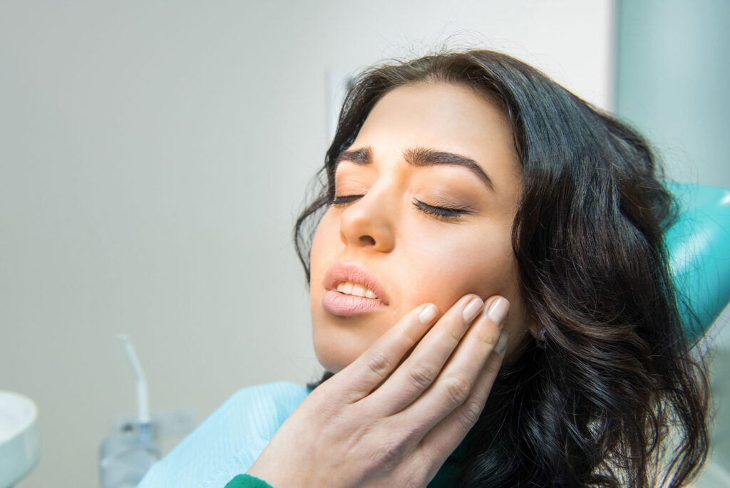 patient having gum disease pain within the dental center