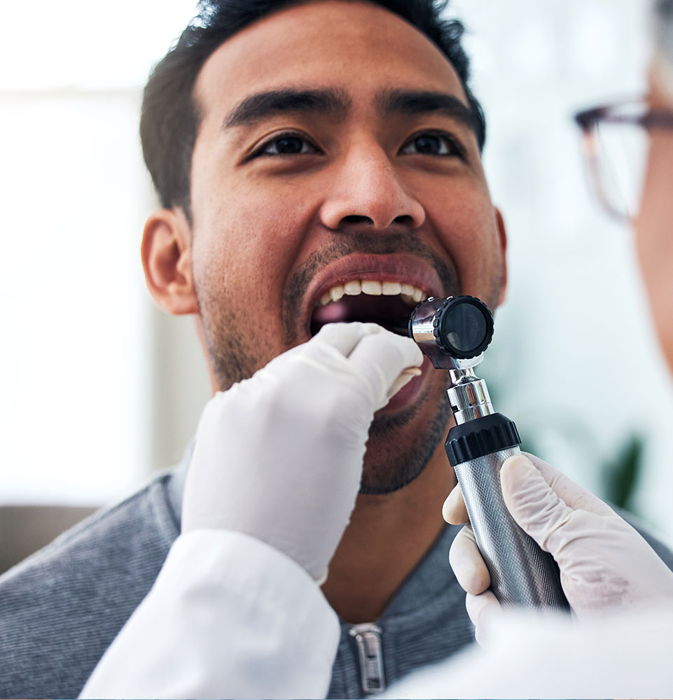 patient having a oral cancer examination