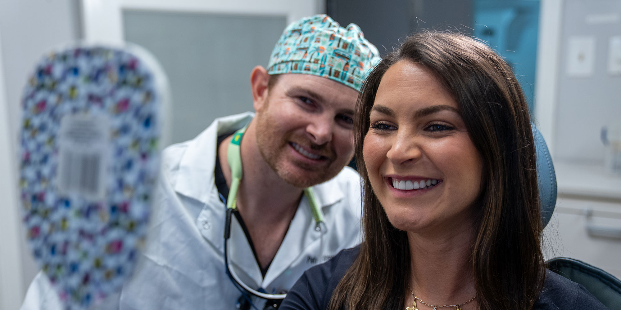 dental patient smiling brightly with doctor after dental patients procedure