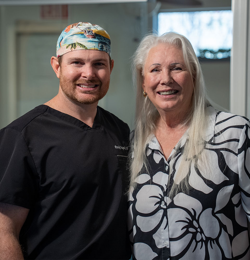 patient and doctor both smiling brightly after patient's dental treatment